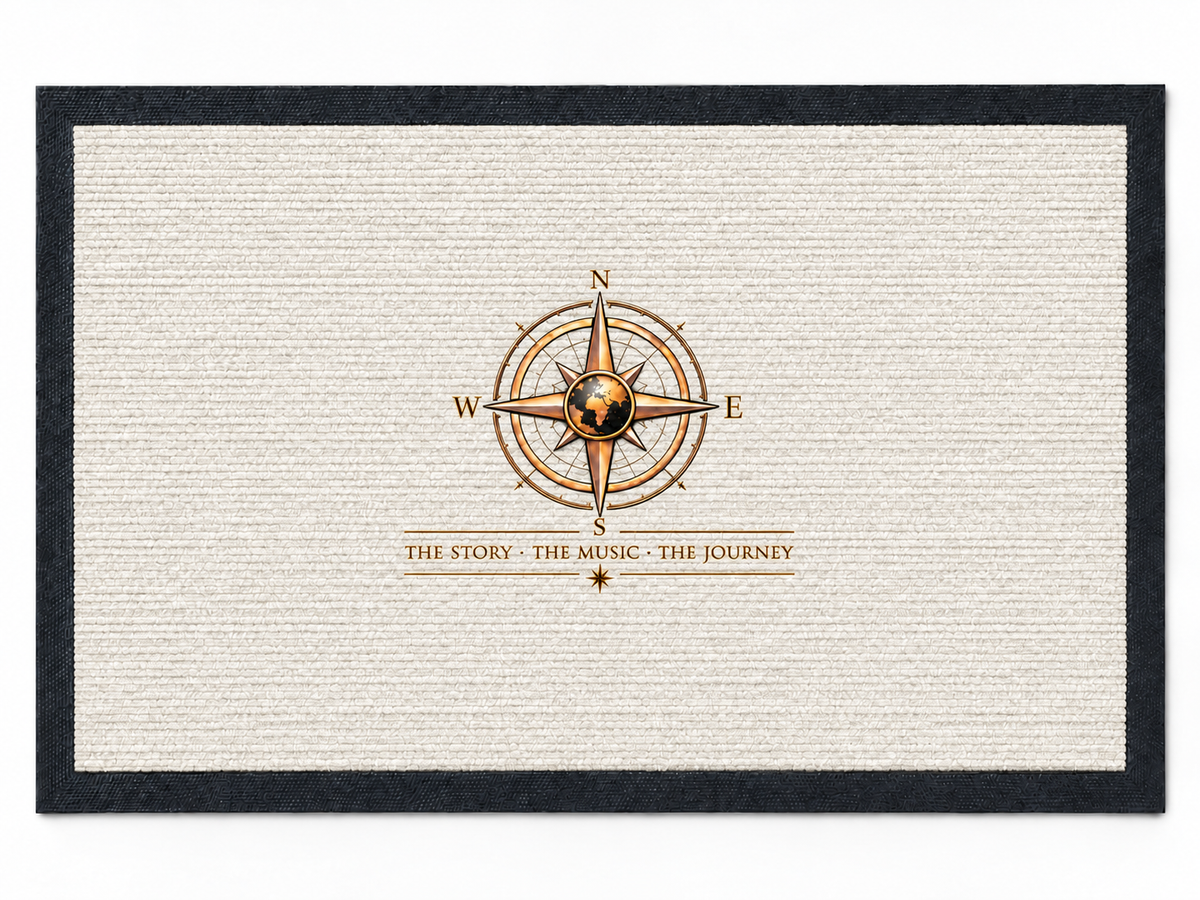 Pexlerian white doormat with black rubber border and gold compass design